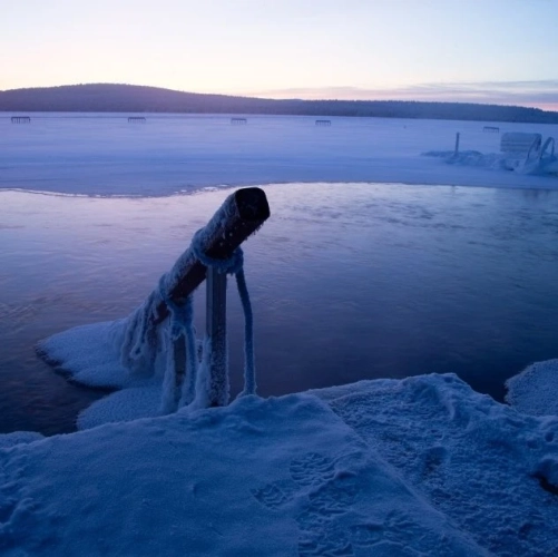 Baignade dans un avanto d'un lac semi-gelé à Noël