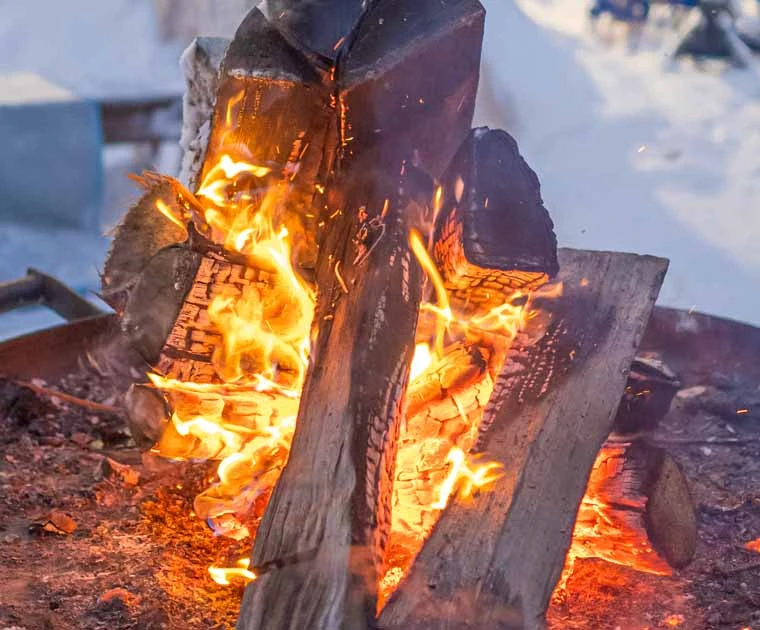 Allumage d'un feu de bois en pleine nature enneigée